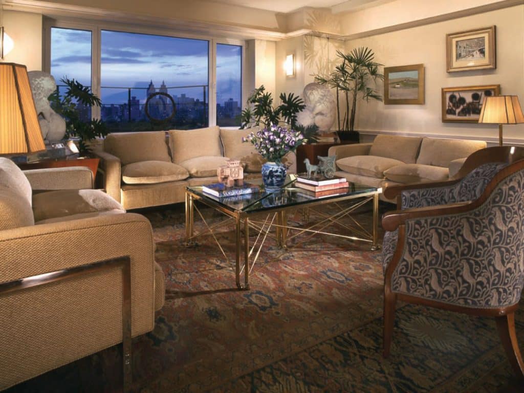 Living room with two couches and two chairs looking out over the city