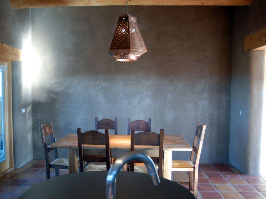 Wood dining area for six with metallic chandelier