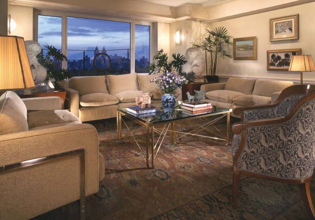 Living room with two couches and two chairs looking out over the city