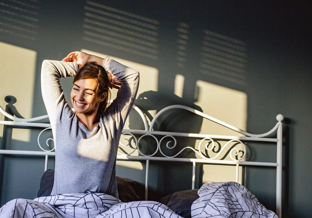 Woman stretching as she wakes up